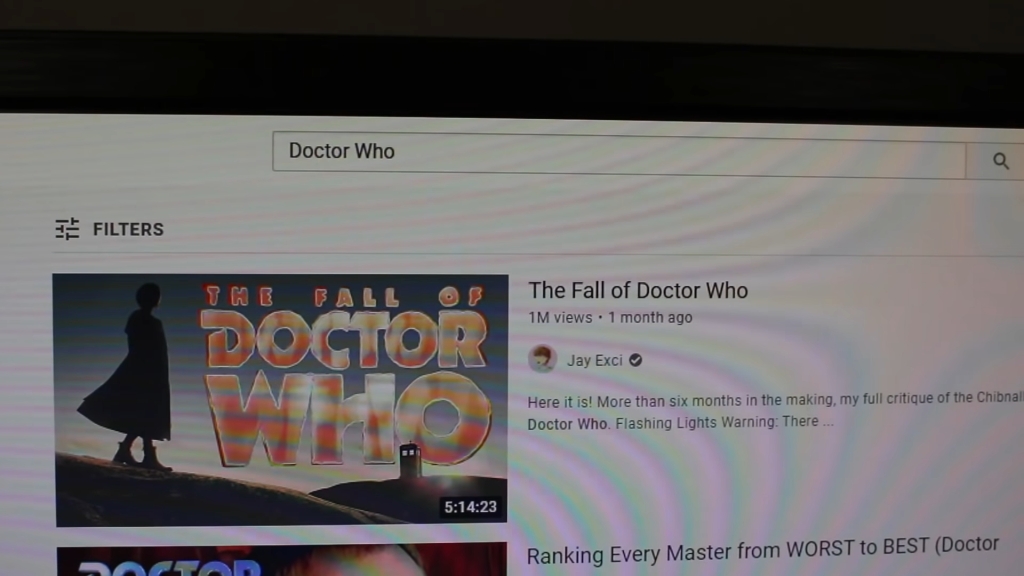 Screenshot of Jay Exci's video about the backlash to her five hour Doctor Who video essay in which she's filming her computer showing her five hour Doctor Who video essay "The Fall of Doctor Who" 